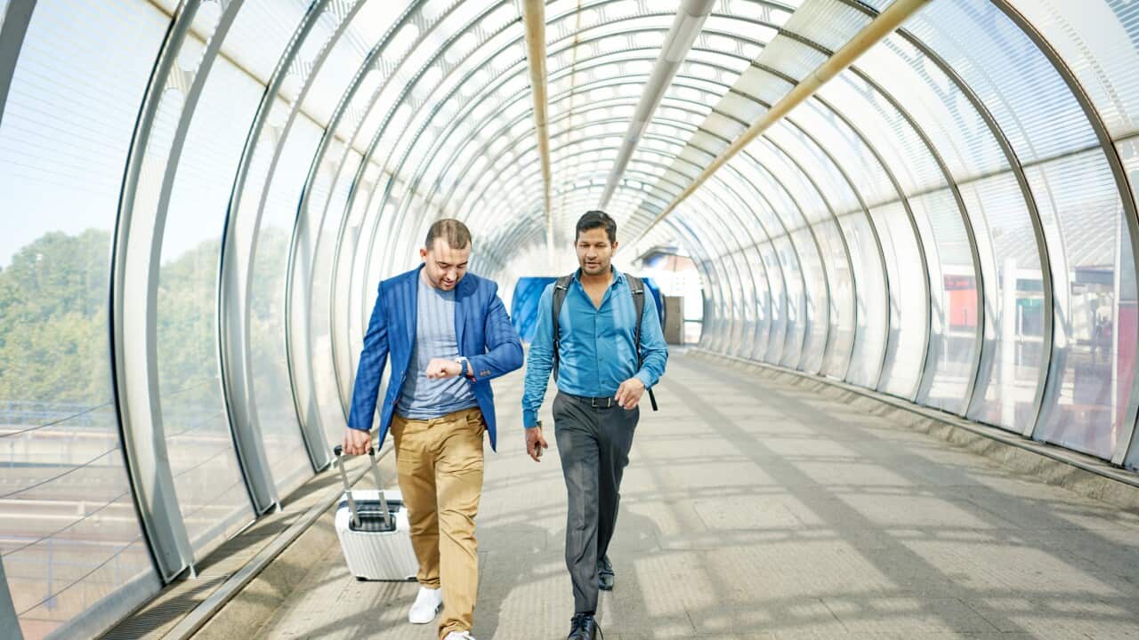 Two men walking together in a hurry