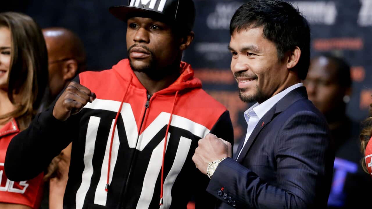 Boxers Floyd Mayweather Jr., left, and Manny Pacquiao pose for photographers during a press conference Wednesday, April 29, 2015, in Las Vegas. The pair are slated to square off Saturday in Las Vegas. (AP Photo/Chris Carlson)