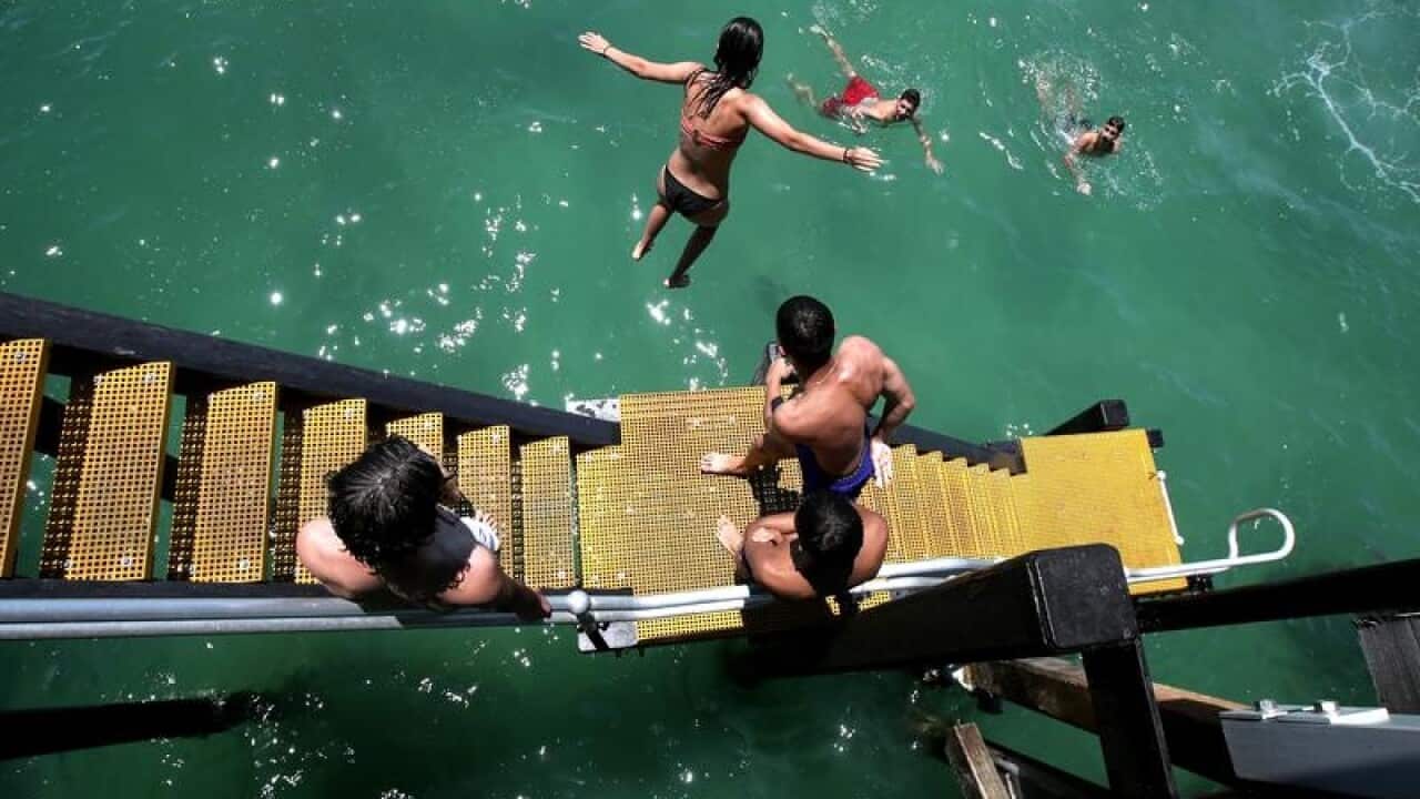 A file image of teenagers leaping into the water at Henley Beach Jetty
