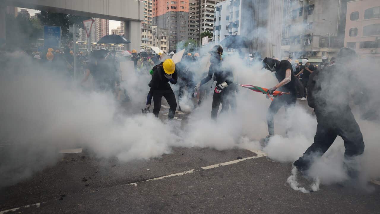 Riot police fire tear gas during a mass rally in Yuen Long.