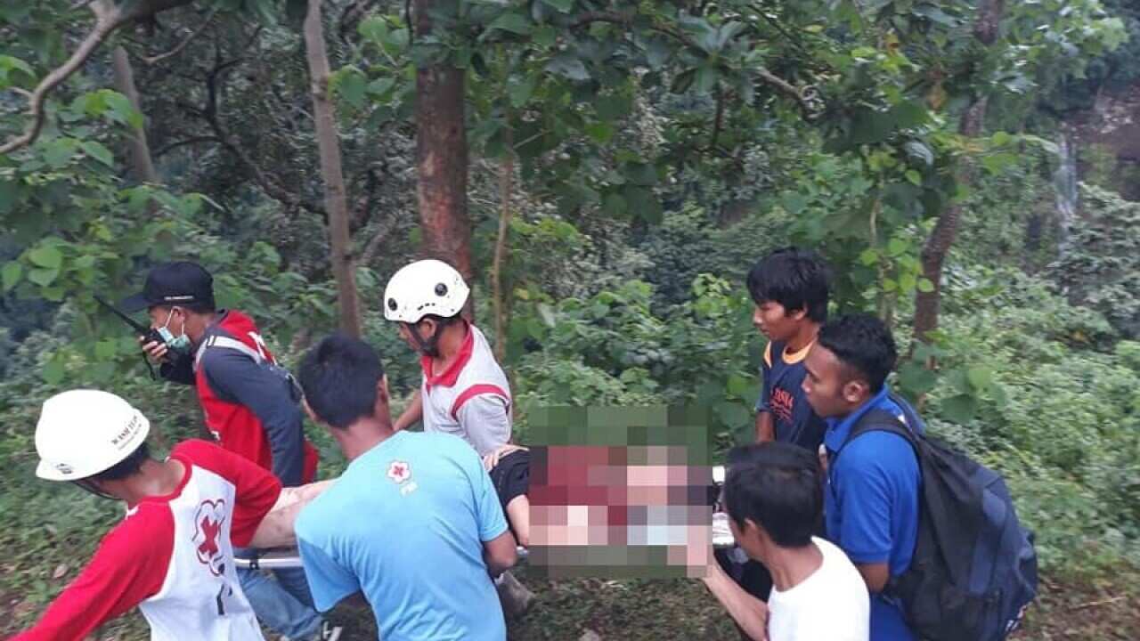 Dozens of tourists are feared trapped after a waterfall site was hit by landslides in the Indonesian holiday island of Lombok.