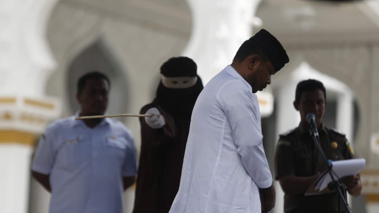 An Acehnese man faces a public caning punishment for having a sexual relationship without being married, in Banda Aceh.