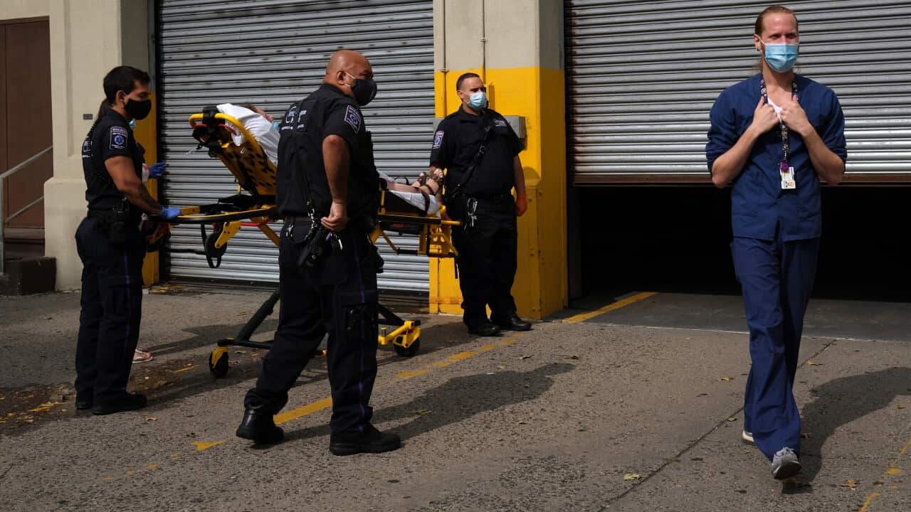 Medical workers deliver a patient to a hospital in Brooklyn, New York City.