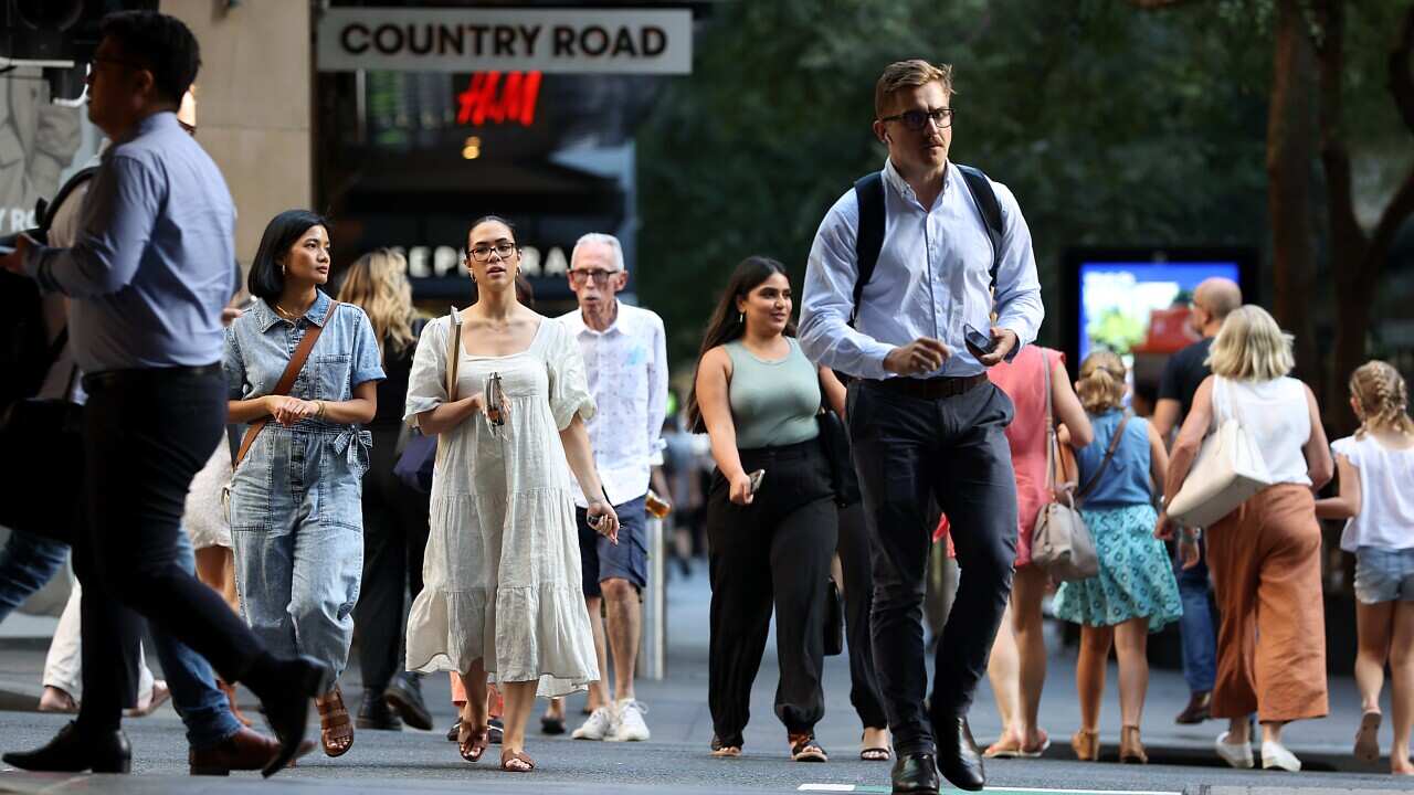 A crowd of people walking down a busy street.