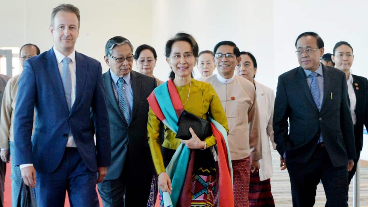 Aung San Suu Kyi and Wouter Jurgens, Netherlands ambassador to Myanmar, speaking as Suu Kyi prepares to leave from Naypyitaw International Airport.