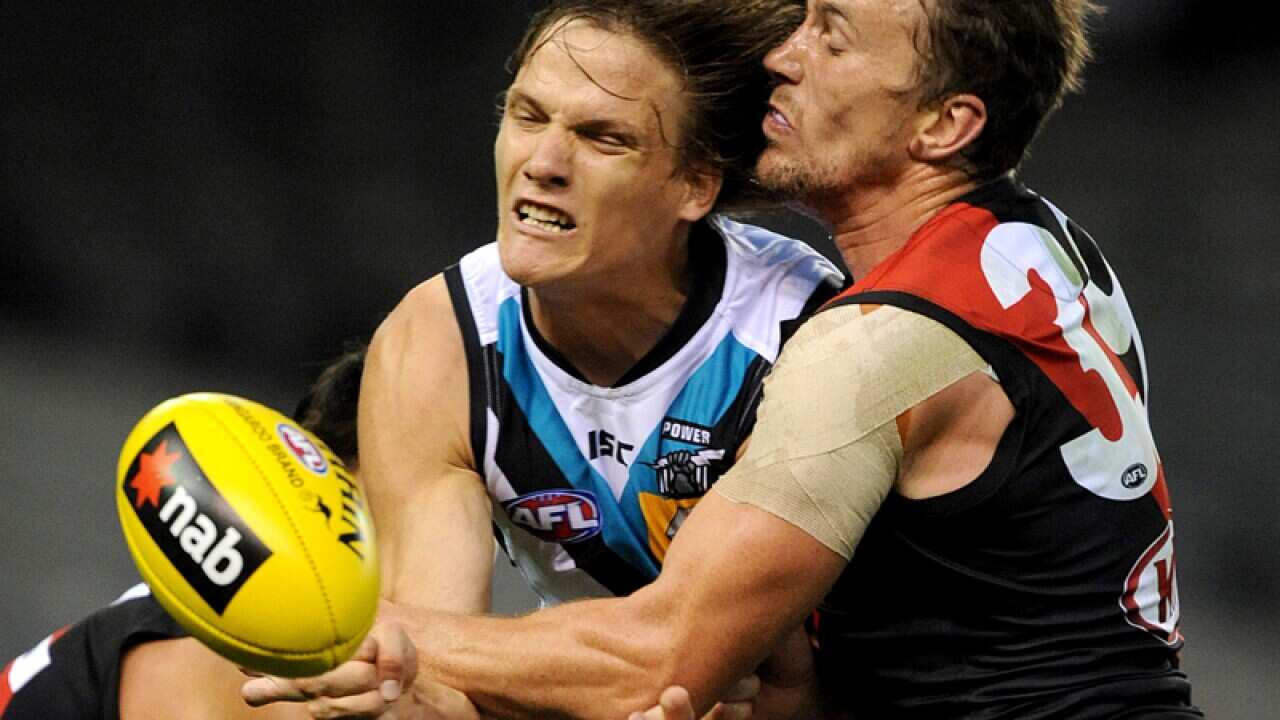 Heath Hocking of Essendon tackles Jared Polec of Port Adelaide