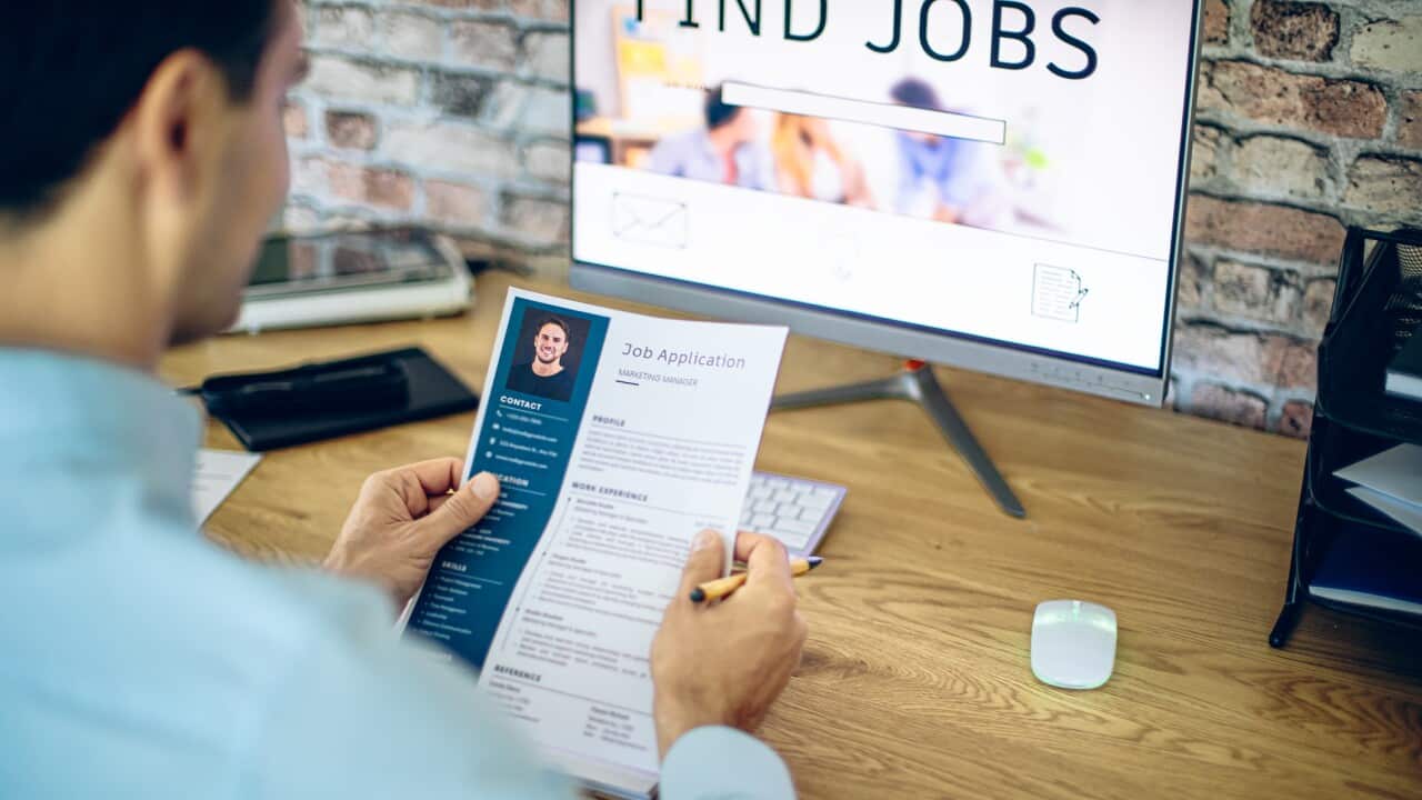 Man holding his resume, while searching a new job