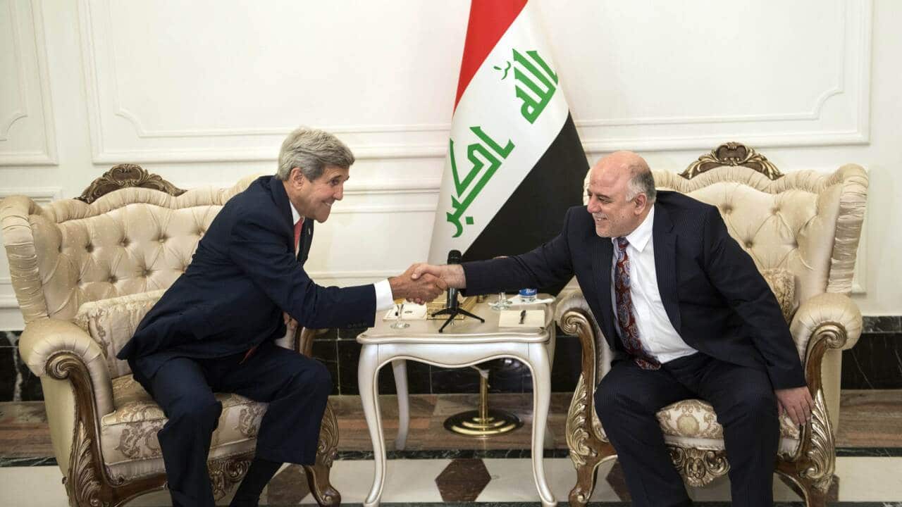 US Secretary of State John Kerry (L) and new Iraqi Prime Minister Haider al-Abadi shake hands after for talks with its new leaders on their role in a long-awaited new strategy against Islamic State jihadists. (AAP/BRENDAN SMIALOWSKI)