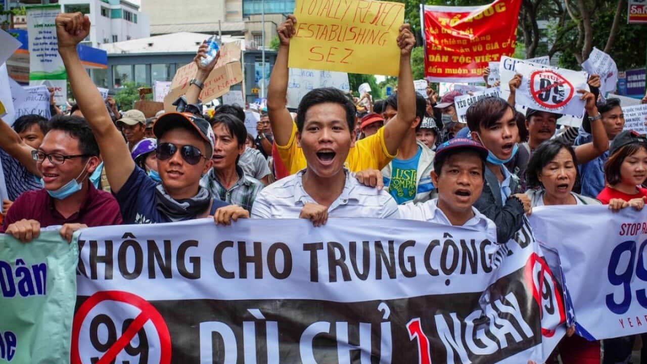 Vietnamese protesters shout slogans against a proposal to grant foreign companies lengthy land leases during a demonstration in HCM City on June 10, 2018.