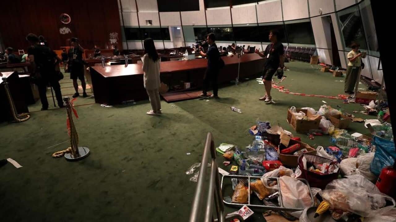 The media are shown around the trashed Legislative Council room