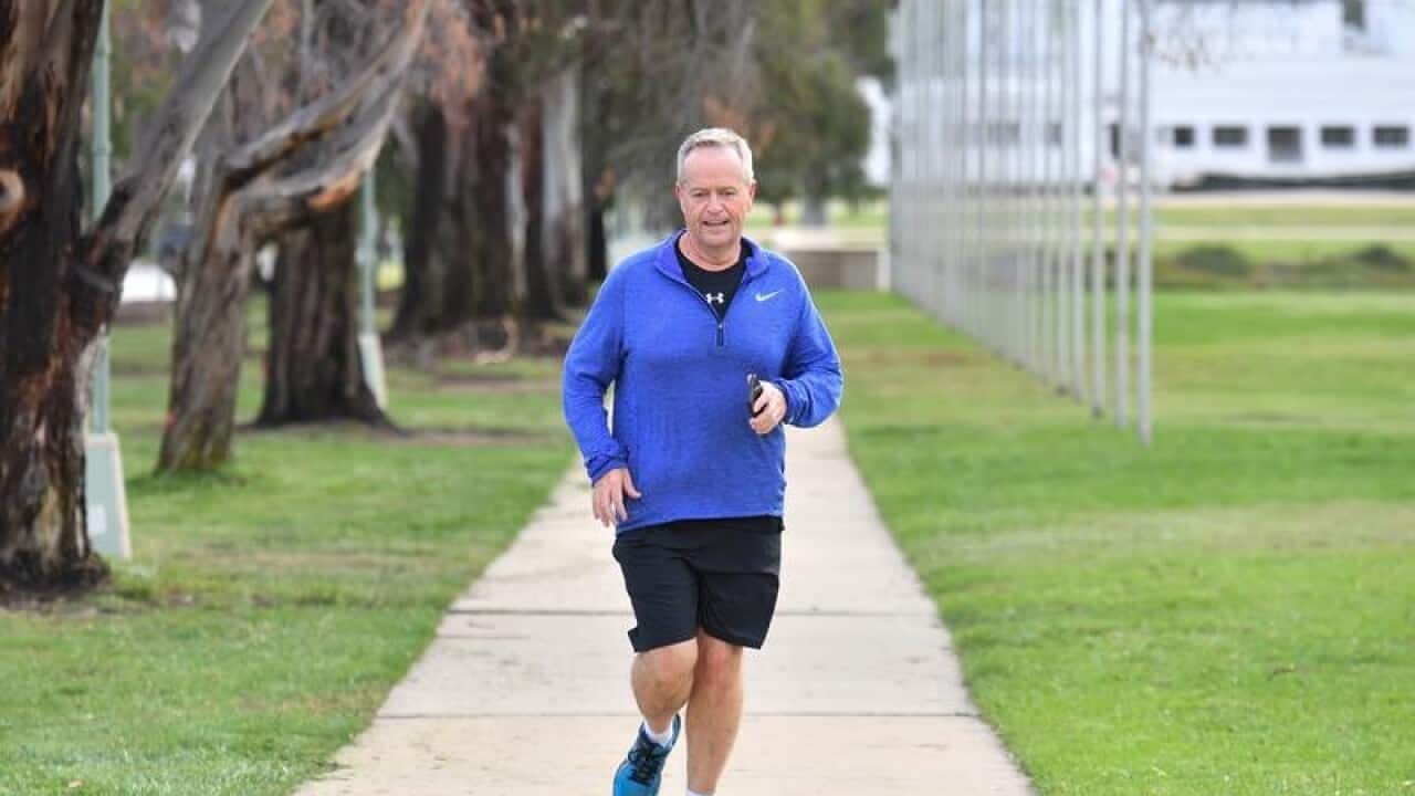 Opposition Leader Bill Shorten jogs to Parliament House.