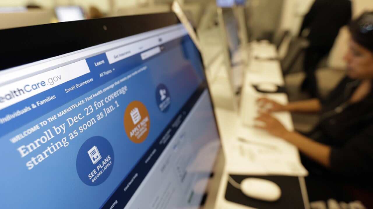 A woman uses a computer to access the Affordable Care Act website