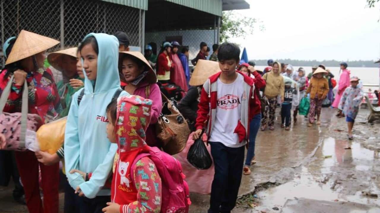 People evacuate as typhoon Tembin approaches in Tra Vinh, Vietnam.