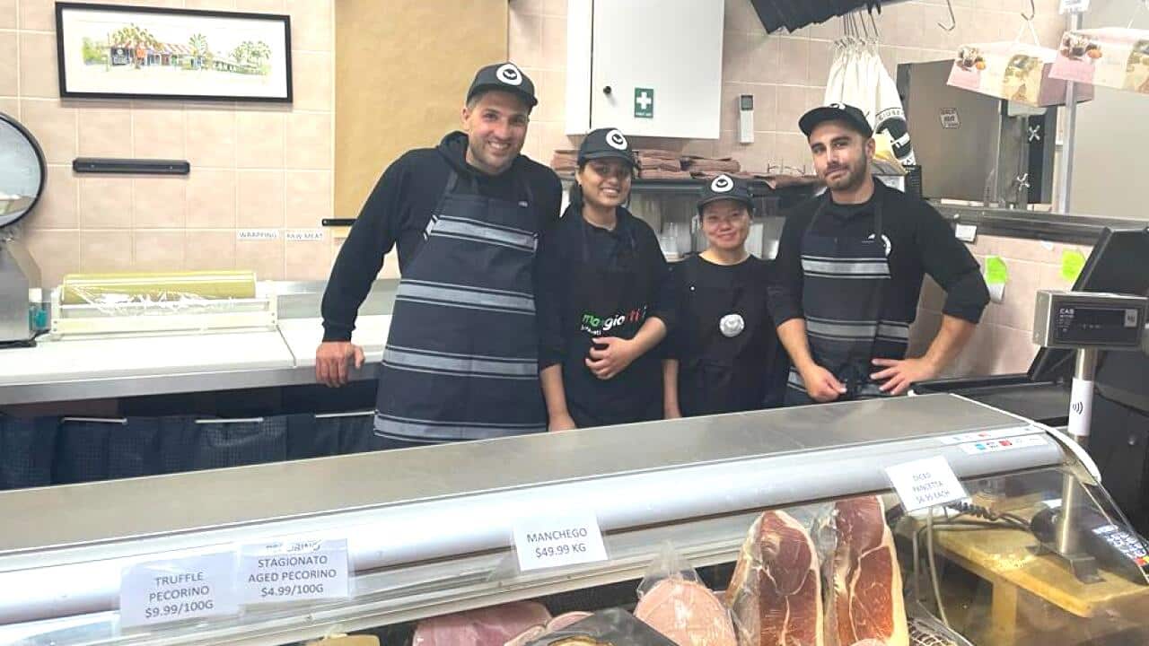 Giuseppe in his shop with his staff.