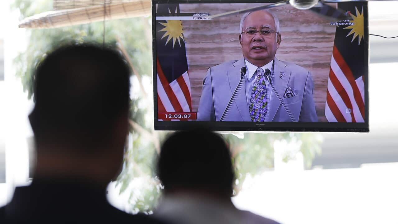 Malaysian Prime Minister Najib Razak is seen on television as he speaks during a nationally televised in Putrajaya, Malaysia, Friday, April 6, 2018. 