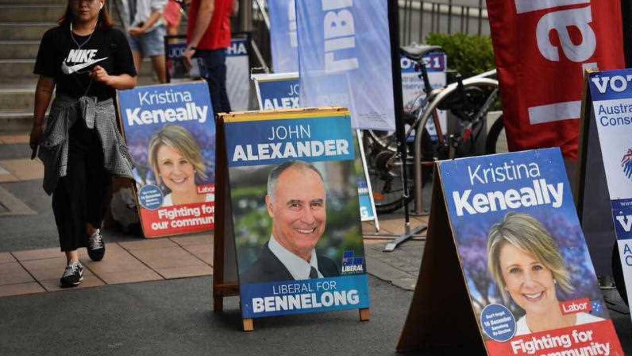 Liberal and Labor campaign posters for Bennelong candidate John Alexander and Kristina Keneally at Epping train station in Sydney, Friday, December 15, 2017.
