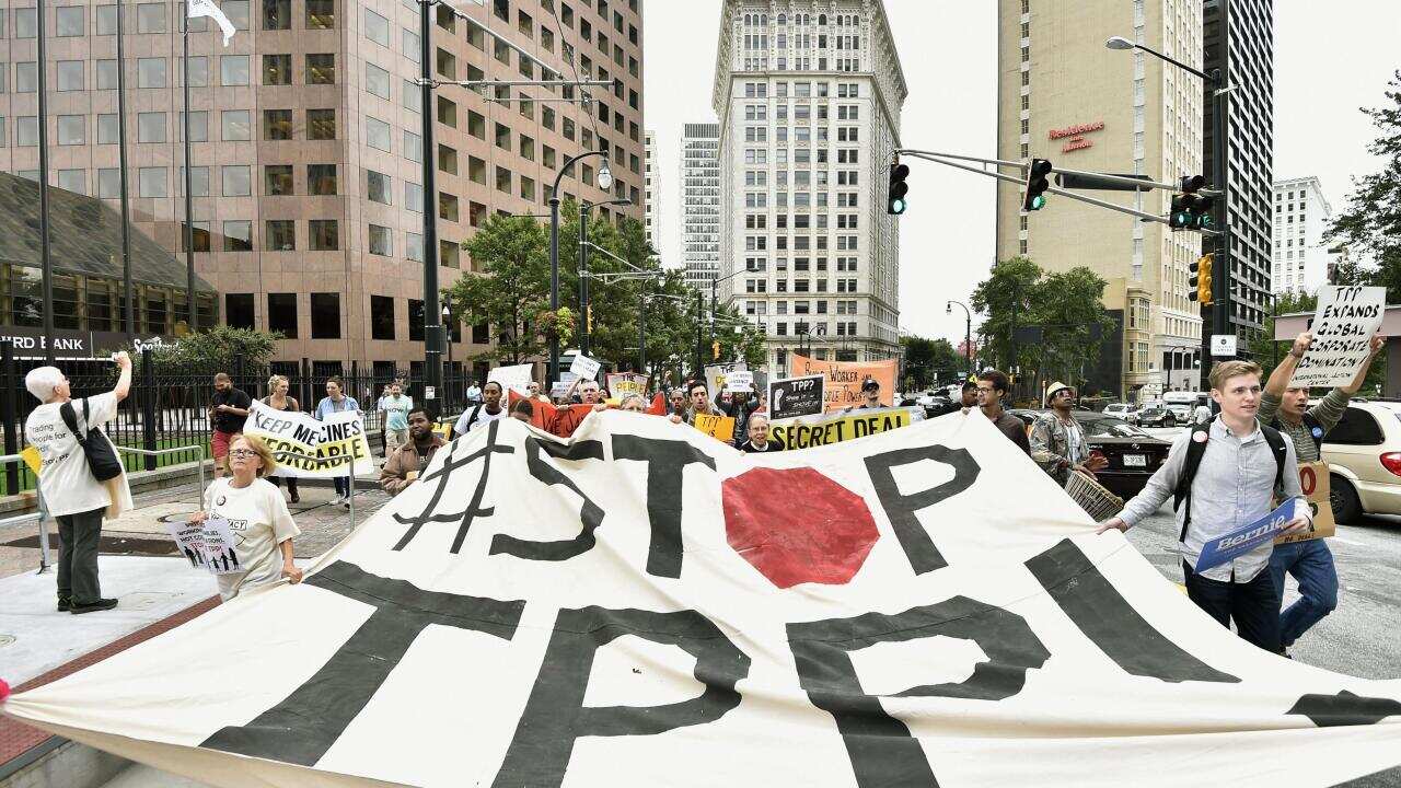 Members of a US civic group march in Atlanta to express opposition to the Trans-Pacific Partnership initiative, near the hotel where ministers from 12 countries are continuing talks