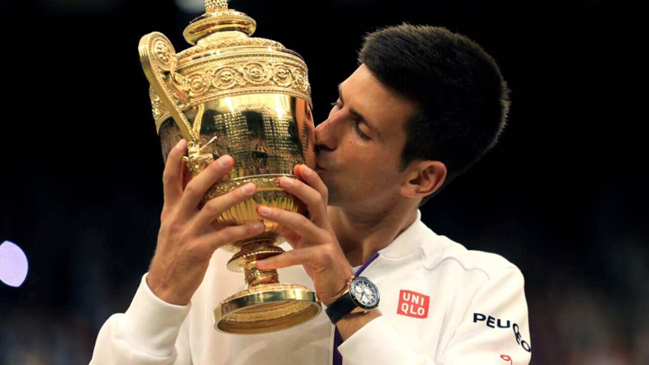 Novak Djokovic lifts the Wimbledon Trophy
