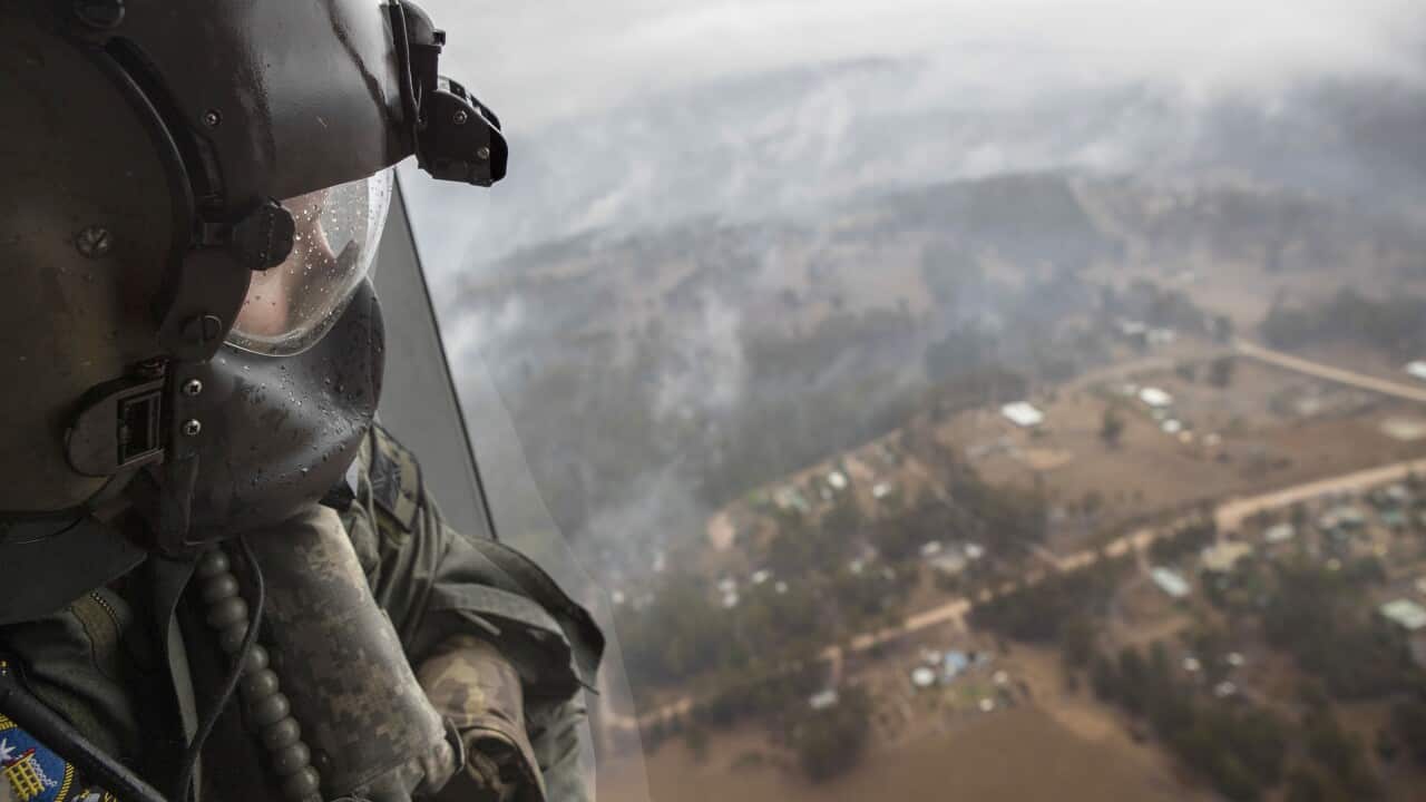 eading seaman aircrew Brendan Menz looking out the door of HMAS Choules' MRH-90 Maritime Support Helicopter over Southern New South Wales, Australia, 6 January 2020. 