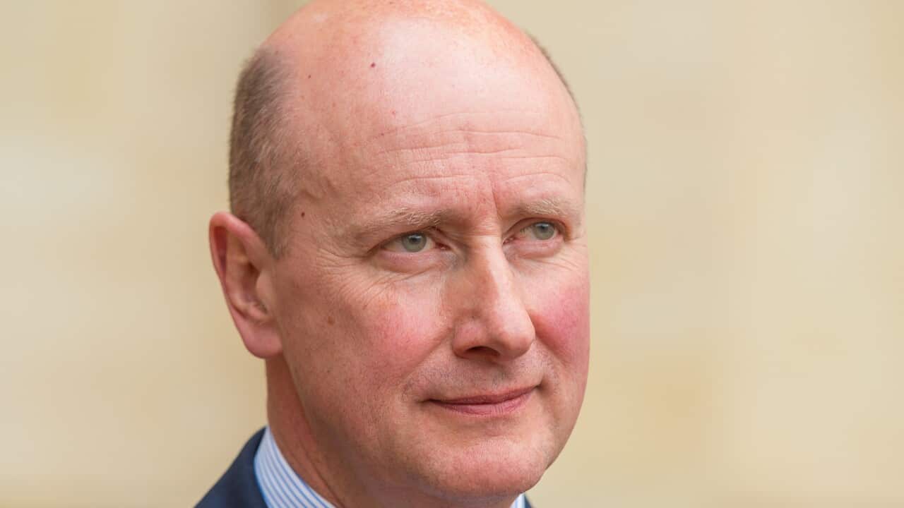 A man stares at the camera