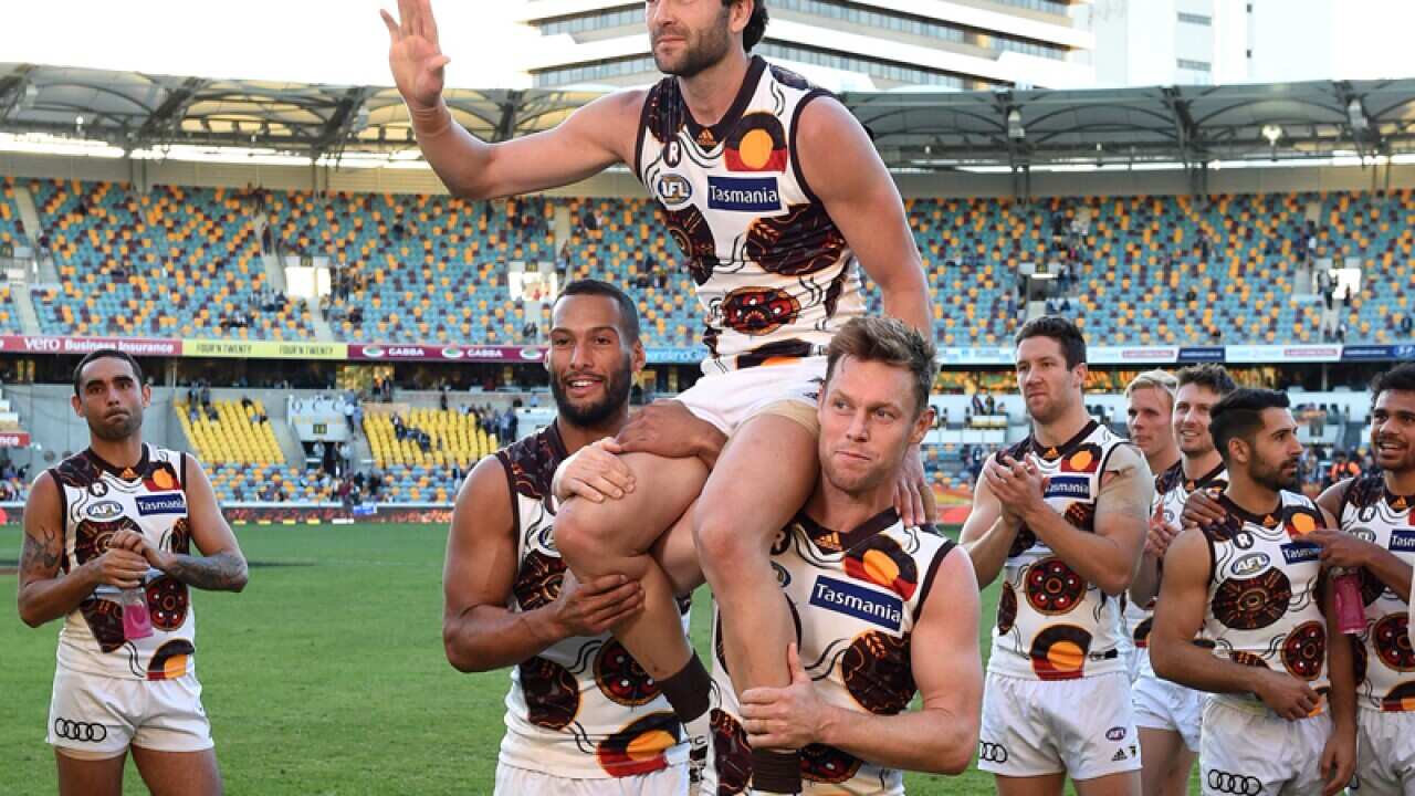 Hawks player Jordan Lewis is chaired from the field