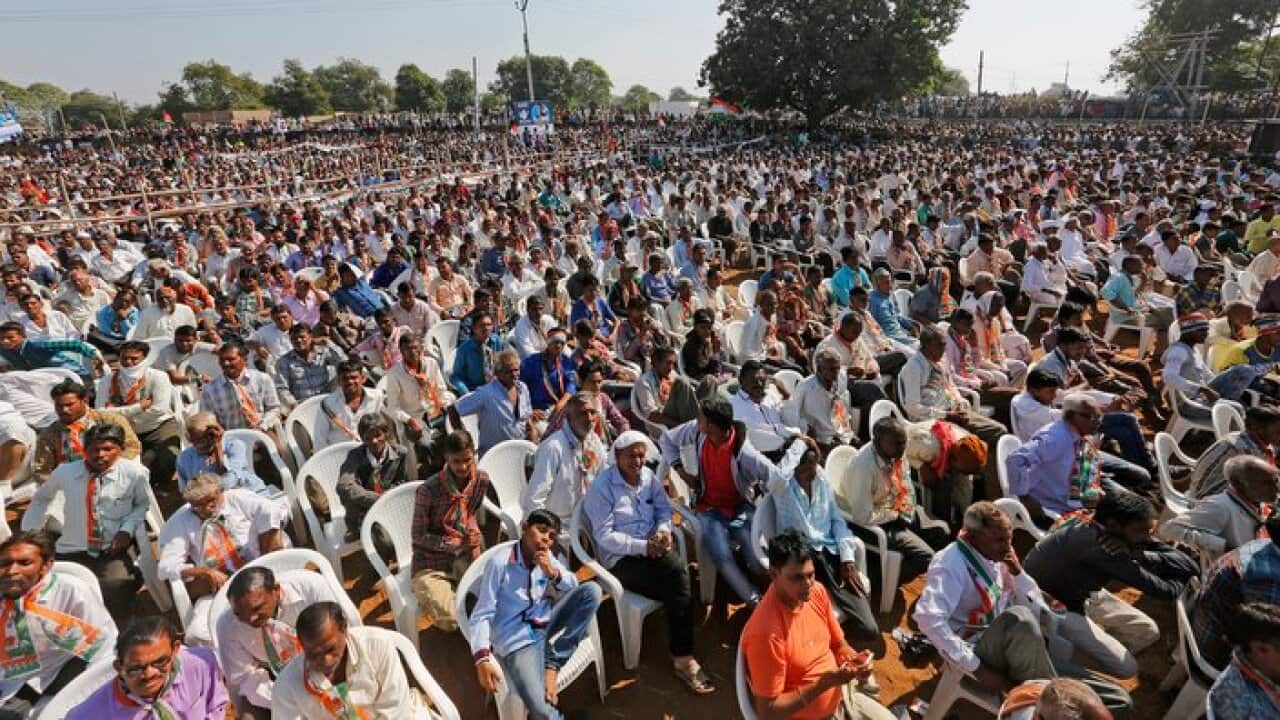 People listen to India's main opposition Congress party Vice President Rahul Gandhi during an election rally near Bayad in Gujarat state's Aravalli district, India, Saturday, Nov. 25, 2017. Gujarat state assembly election will be held on Dec. 9 and Dec. 1
