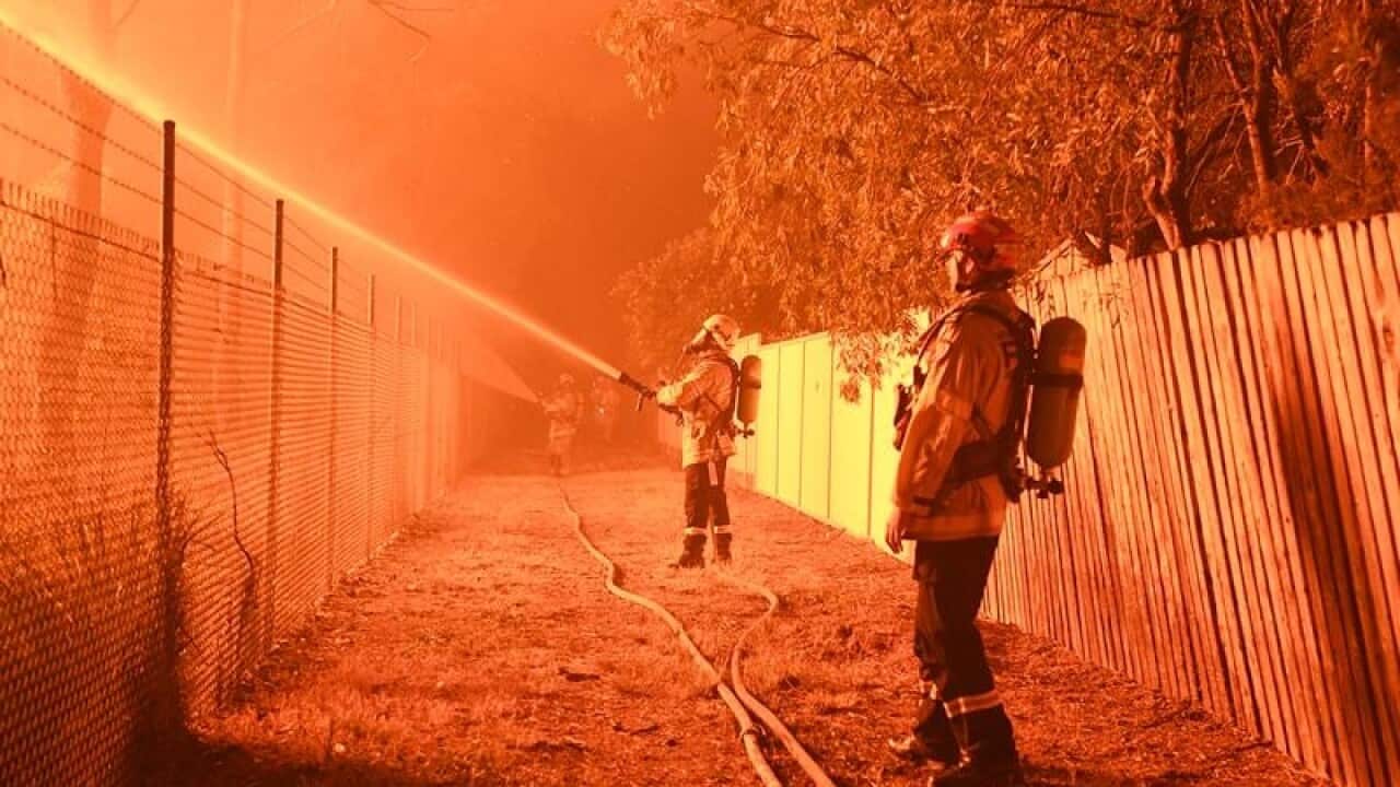 Firefighters fight flames close to homes in Corryton Court.