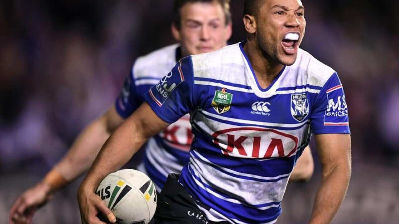 Moses Mbye celebrates after scoring a try.