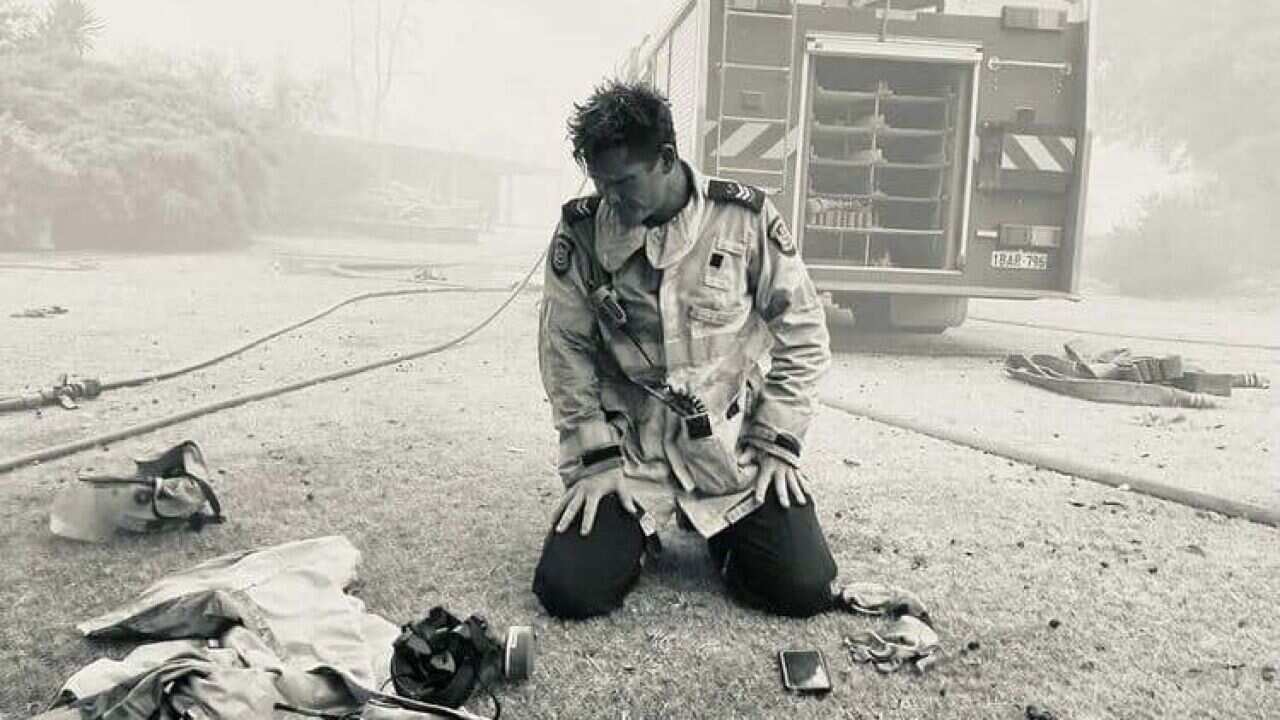 Career Firefighter Mick Dybac captured this powerful moment of fellow Daglish Senior Firefighter David Ellis, in front of a home they had just saved in the Wooroloo bushfire.