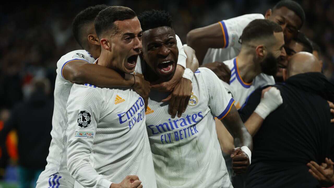 Real Madrid's striker Vinicius Jr (R) and defender Lucas Vazquez (L) celebrates the team's 2-3 goal during the UEFA Champions League quarter final second leg soccer match between Real Madrid and Chelsea held at Santiago Bernabeu Stadium, in Madrid, Spain,