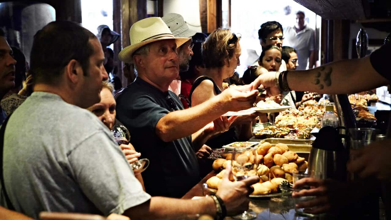Man in hat at tapas bar