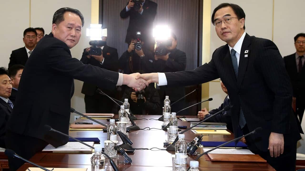 South Korean Unification Minister Cho Myoung-gyon, right, shakes hands with the head of North Korean delegation Ri Son Gwon during their meeting.