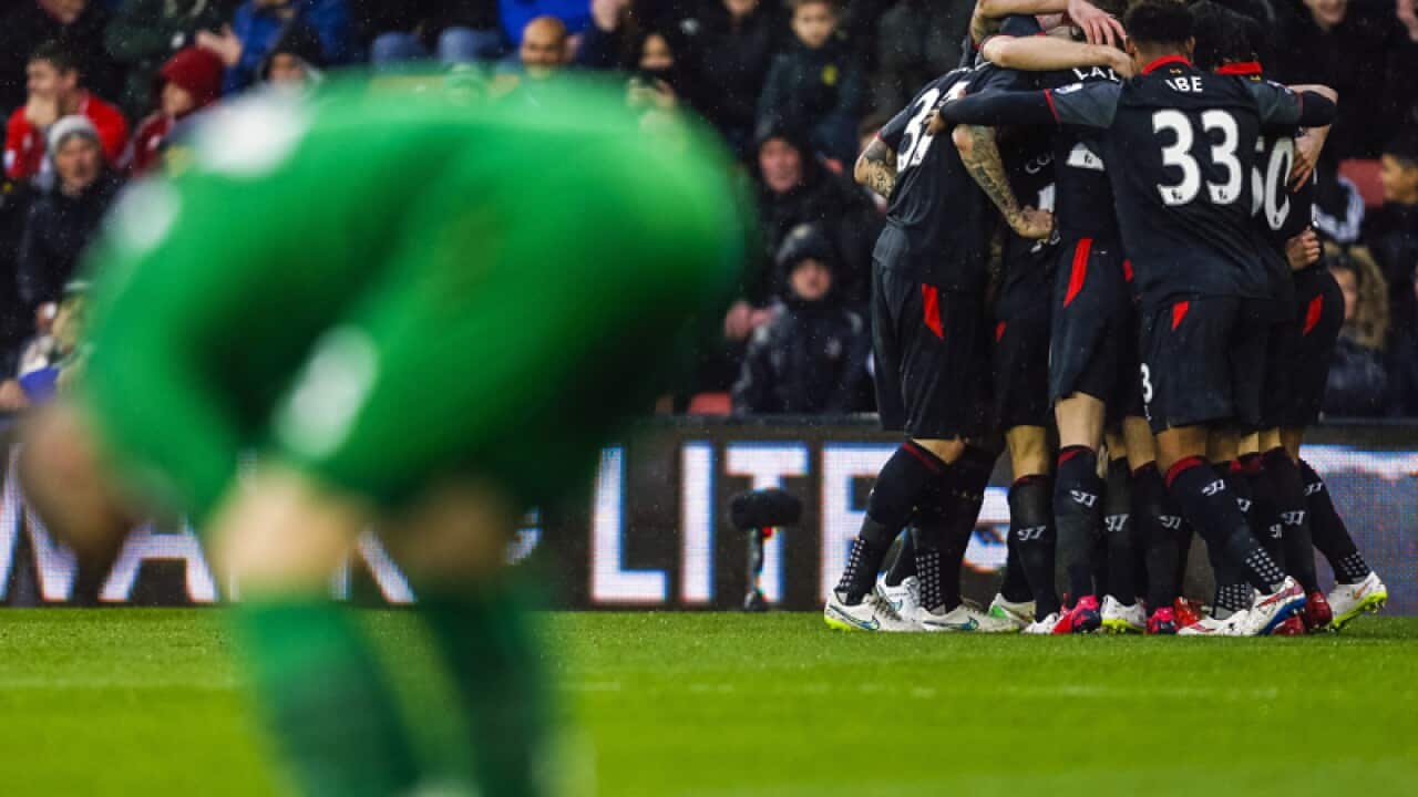 Southampton's Fraser Forster reacts (L) as Liverpool celebrate