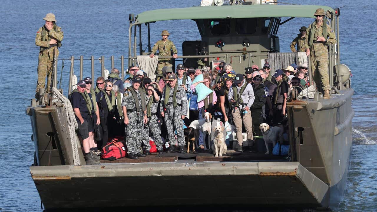 Evacuees disembarks the HMAS Choules in Hastings, Victoria, on board landing boats after fleeing bushfires.