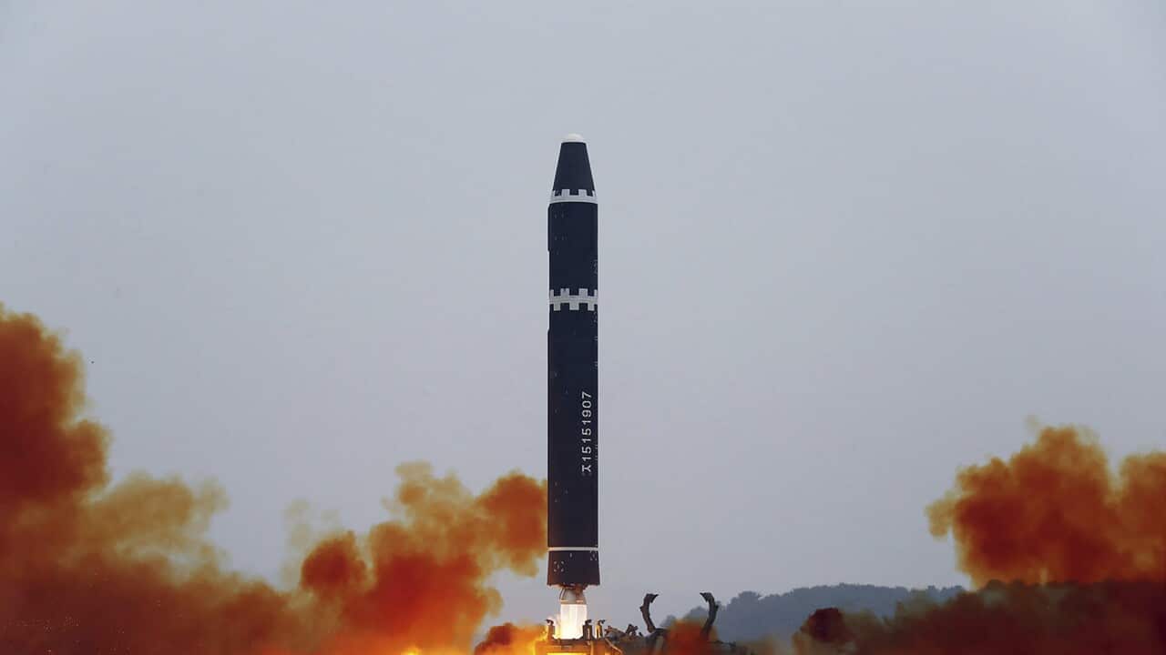 The test launch of the Hwasong-15 intercontinental ballistic missile with blasts and smokes surrounding it