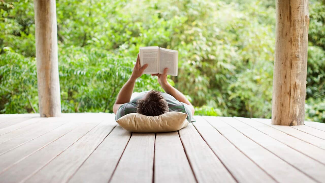 Man reading on porch in remote area