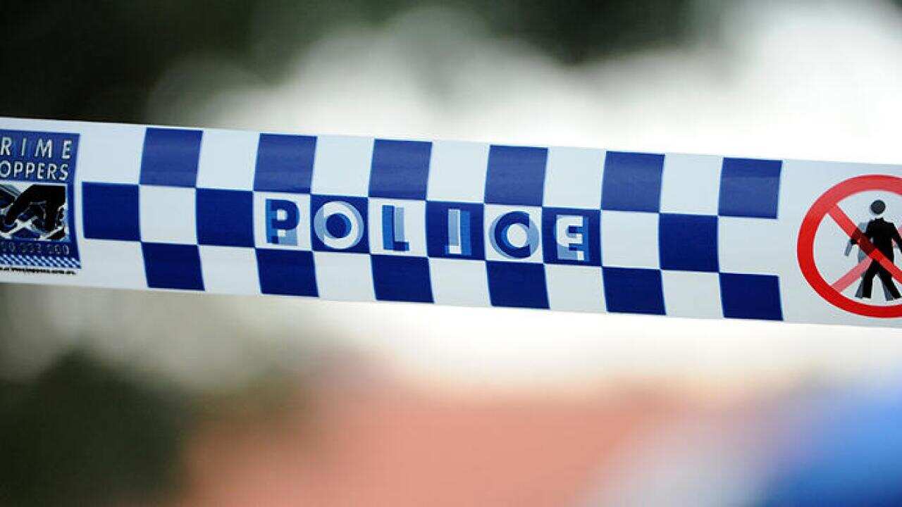 Police tape outside a home where a six week-old girl was found dead in a house in Newcastle, Friday, July 24, 2015. (AAP Image/Joel Carrett) NO ARCHIVING