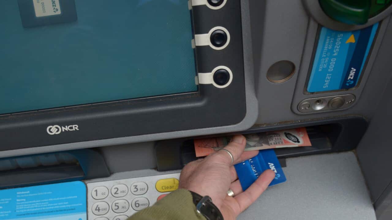 A customer uses an ANZ automatic teller machine to withdraw cash, Monday, May 7, 2012. (AAP Image/Dean Lewins) NO ARCHIVING