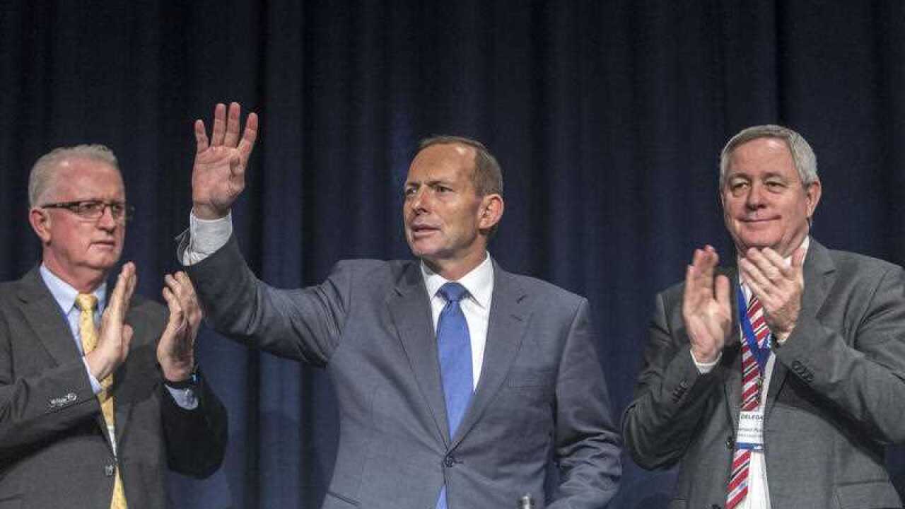 LNP delegates including Bruce McIver and Bernard Ponting congratulate Australian Prime Minister Tony Abbottafter his address at the Liberal National Party.