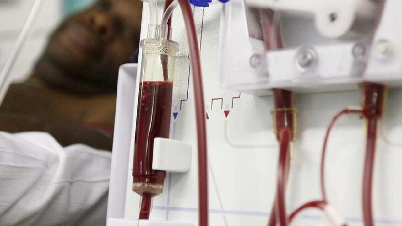 A patient receiving treatment on a dialysis machine