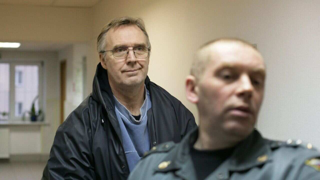 Colin Russell from Australia being escorted into a court in the northern Russian city of Murmansk - AAP.jpg