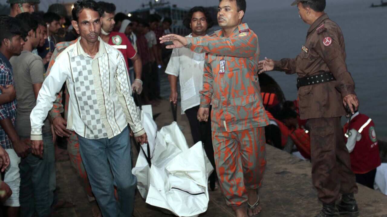 Bangladeshi rescue workers carry the body of a ferry victim