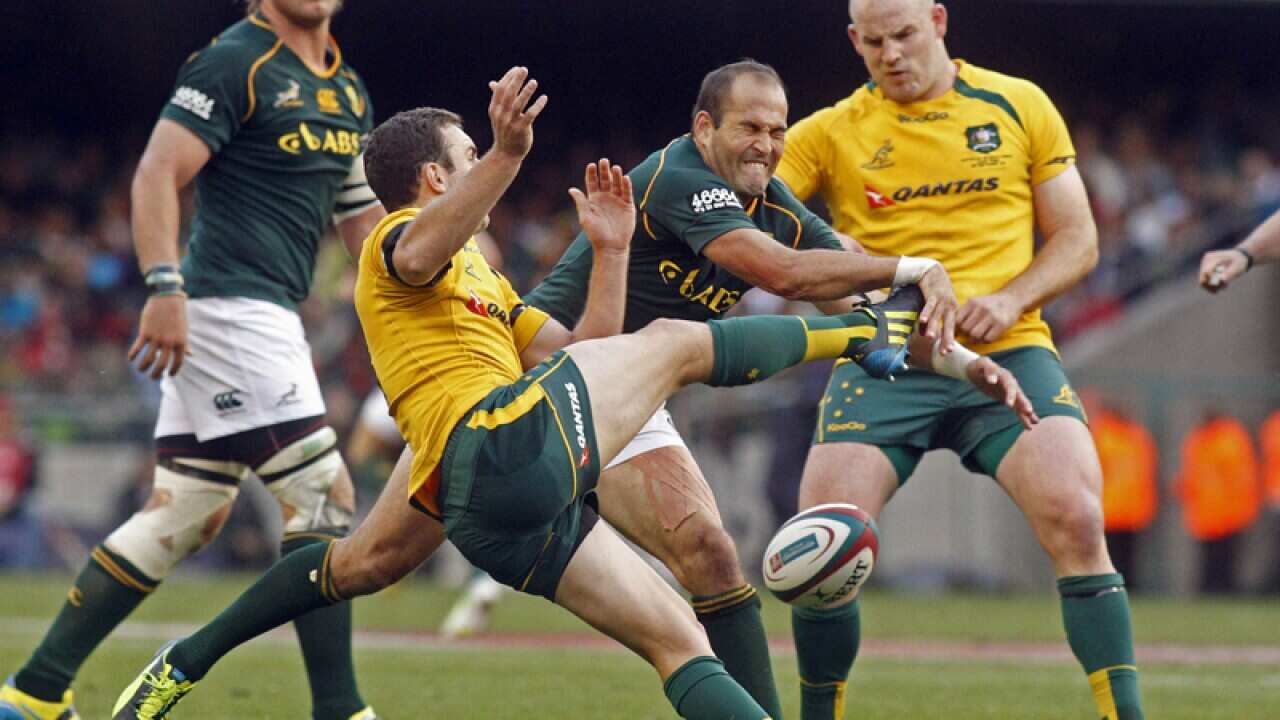 South African Fourie du Preez, center, against Australia's Nic White