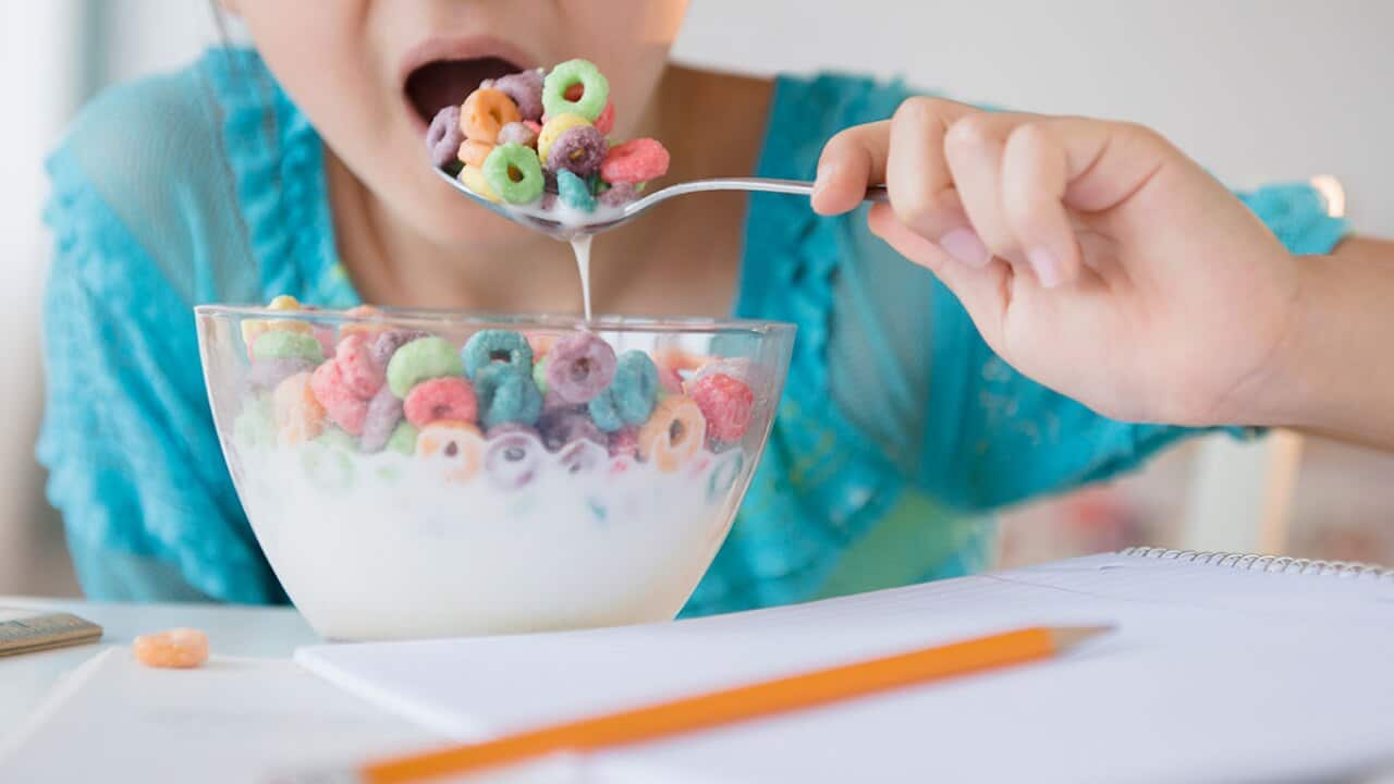 Girl eating sugary cereal 