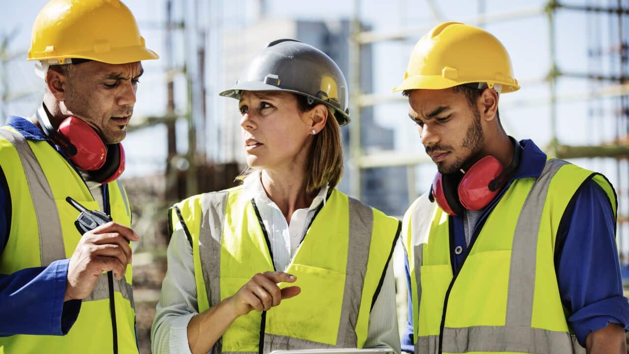Architects using digital tablet at site