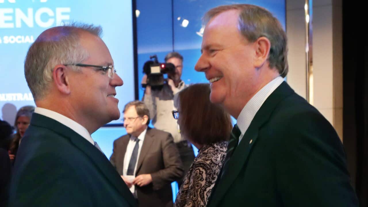 Former Australian Treasurer Peter Costello (left) speaks with Australian Prime Minister Scott Morrison at the Melbourne Institute Economic and Social Outlook Conference in Melbourne, Thursday, October 11, 2018. (AAP Image/David Crosling) NO ARCHIVING
