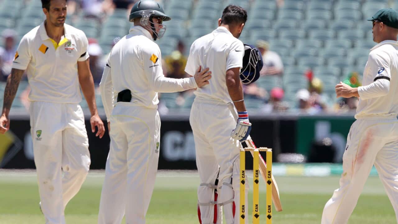 India's Virat Kohli (2R) and Mitchell Johnson, (left).