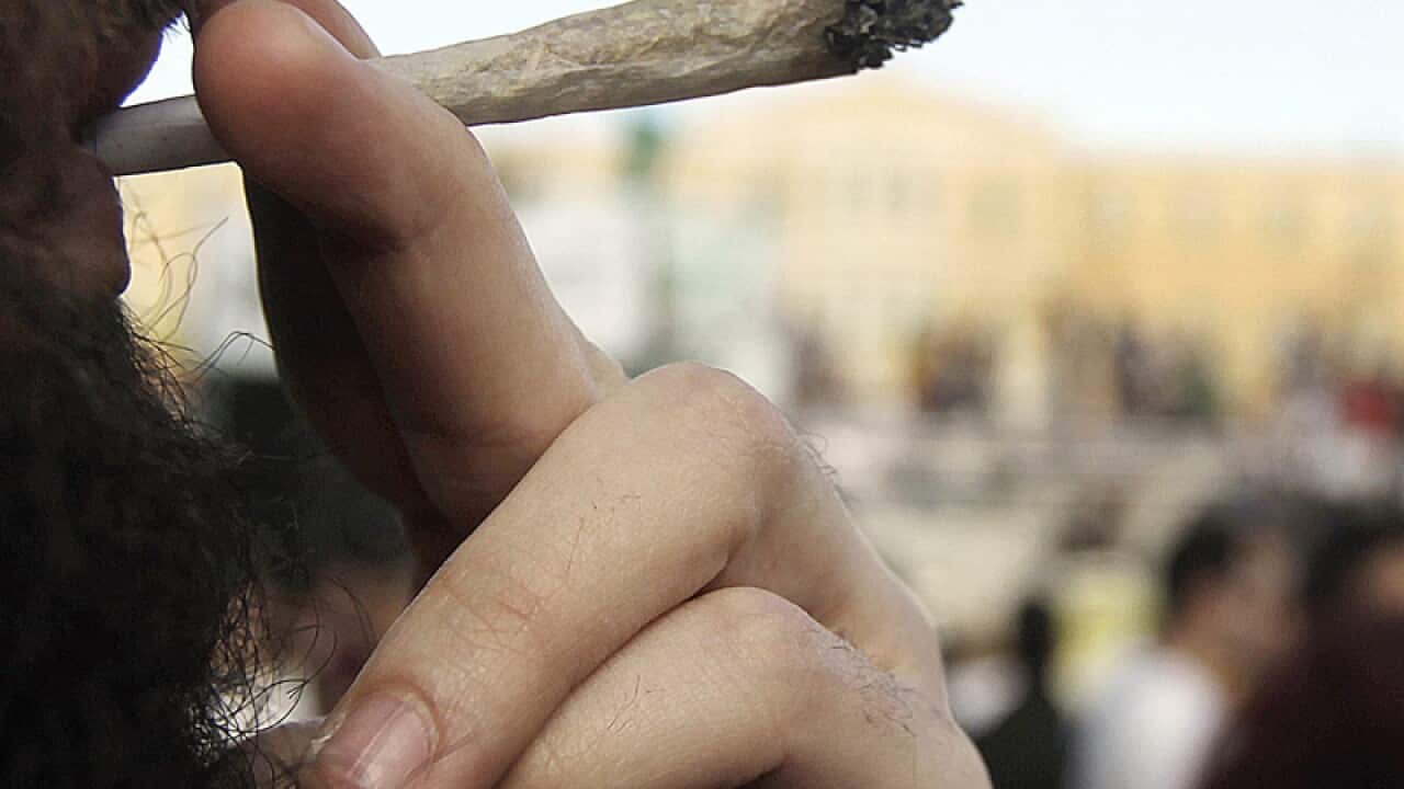 A young man smokes a cannabis