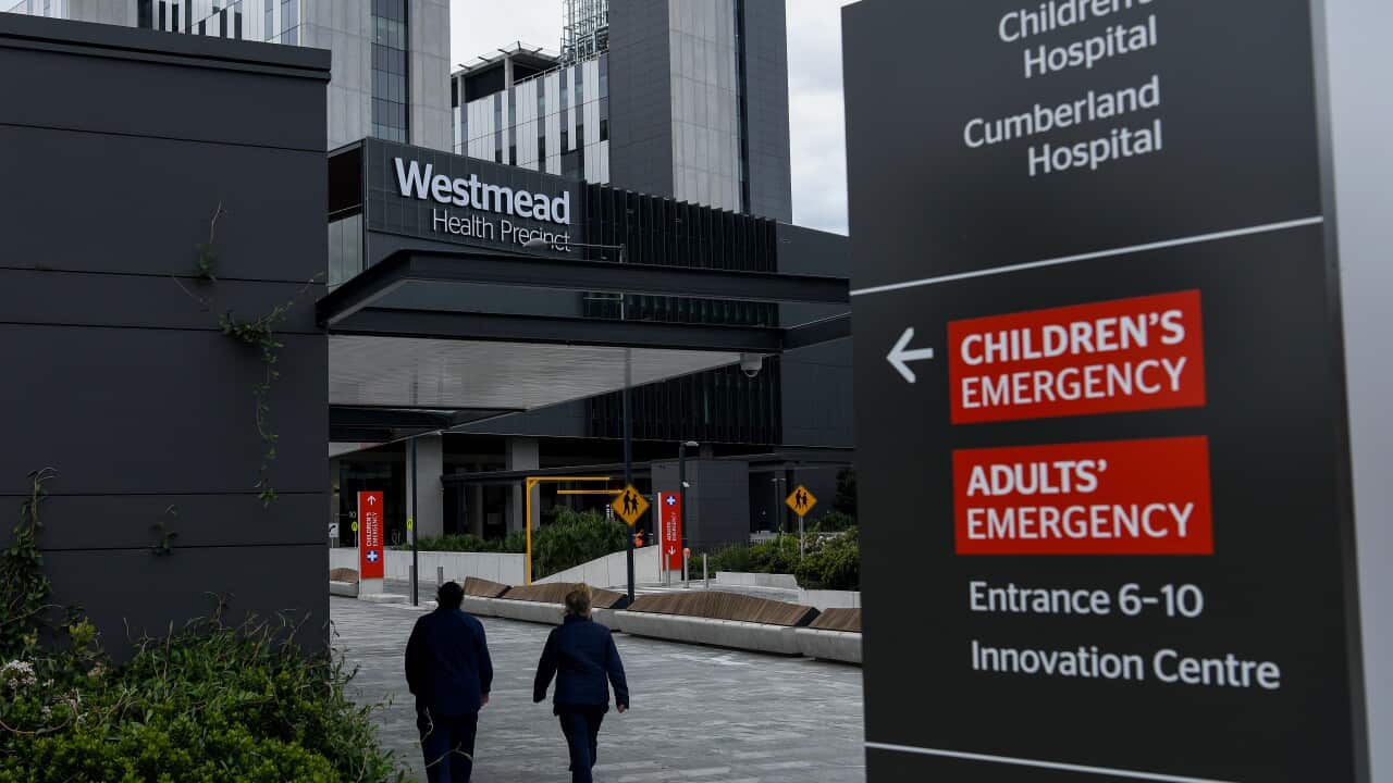 People walking by the entrance to Westmead hospital.
