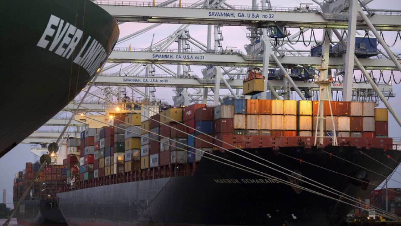 Ship to shore cranes stack shipping containers at the Port of Savannah in Savannah, Georgia, USA